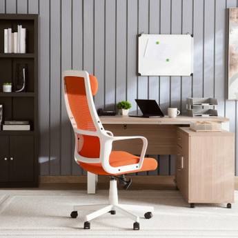 Orange office chair in front of a wooden desk with a computer setup.