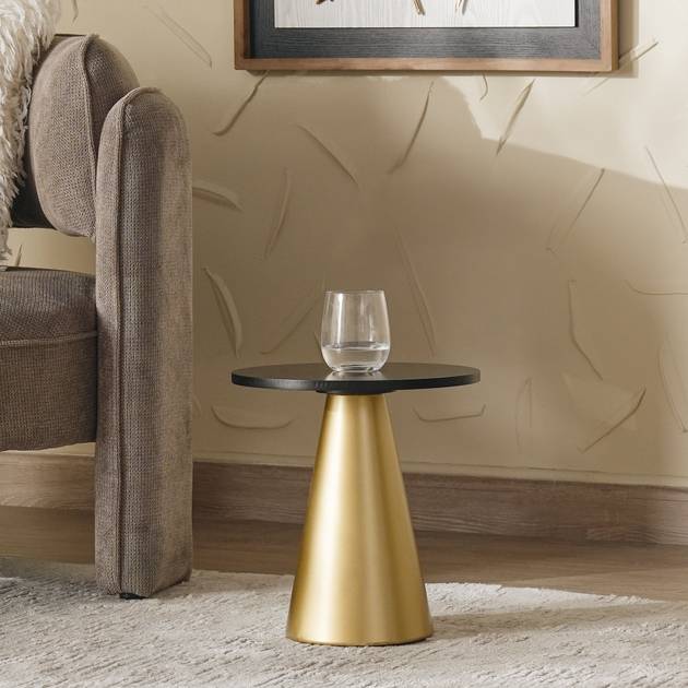 Gold side table with a black top in a living room setting