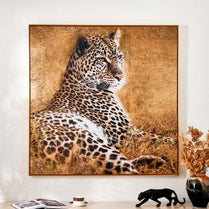 Leopard painting on a wall with decorative items below