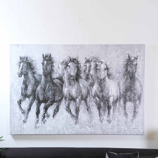 Canvas print of horses running in the snow on a white wall.