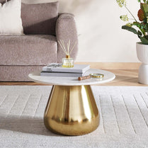 Coffee table with gold base and white top in a living room setting