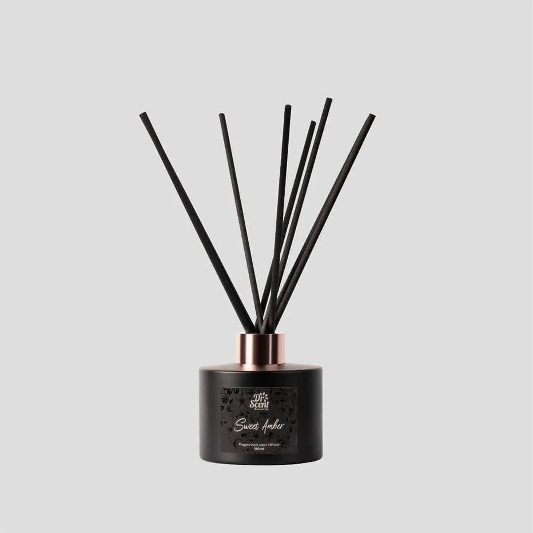 Black diffuser with sticks on a gray background