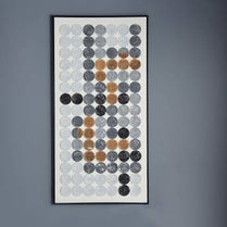 Framed artwork with circular patterns on a gray wall