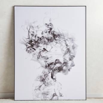 Abstract black and white artwork on a plain wall