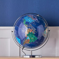 World globe on a stand against a blue wall- Vasco Globe Table Lamp_ 40cm LED USB Powered.
