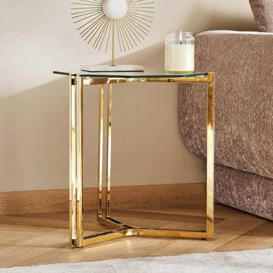 Gold side table with glass top in a living room setting
