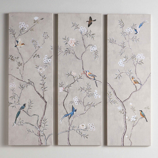 Three panels of wall art with floral and bird designs on a beige background