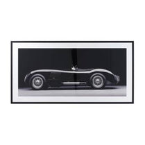 Framed black and white photograph of a classic car on a white background