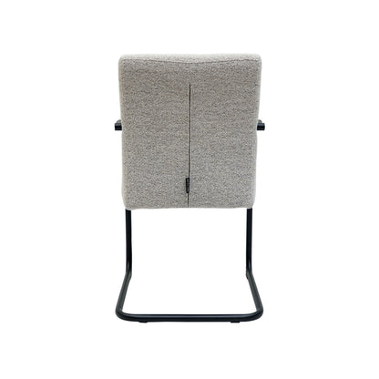 Gray cushioned chair with black metal frame on a white background