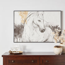 Framed artwork of a horse on a wall above a wooden console table with decorative items.