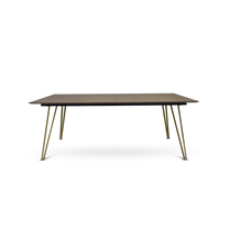 Rectangular table with wooden surface and brass legs on a white background