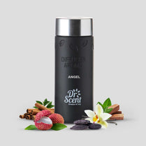 Black diffuser aroma bottle with silver cap, surrounded by cinnamon sticks, lychees, and a flower on a light gray background.