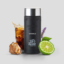 Black diffuser aroma bottle with 'Dr. Scent' branding, surrounded by a glass of iced tea, a crystal, and a lime on a light gray background.