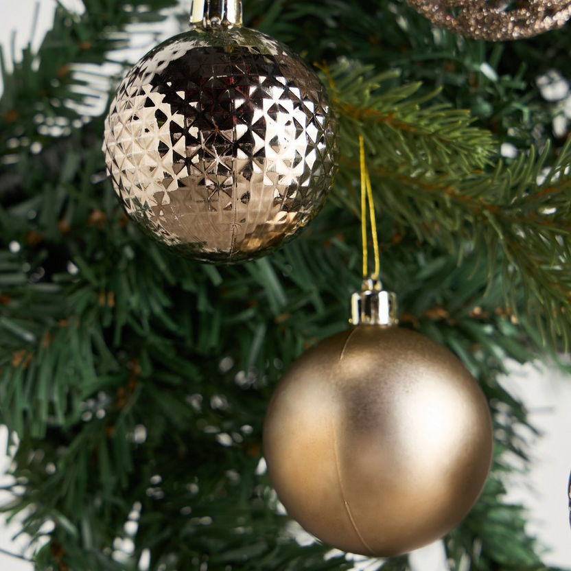 Decorative Christmas ornaments on a tree with a gold and silver ornament.