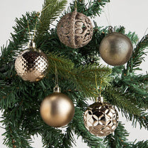 Decorative Christmas ornaments on a tree with a plain background