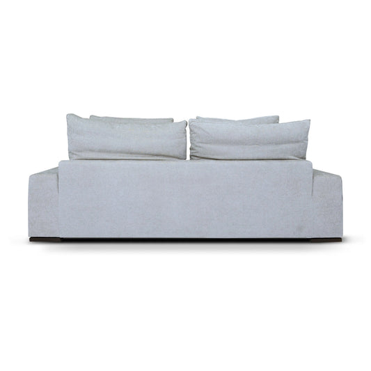 Light gray sofa with three cushions on a white background