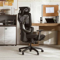 Ergonomic office chair in a home office setting with a desk and computer.