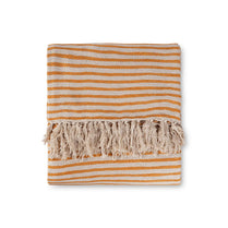 Striped orange and beige towel with fringes on a white background