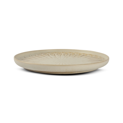 Beige ceramic plate with textured design on a white background