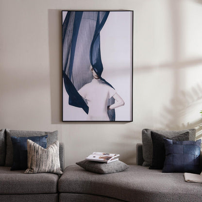 Gray sofa with decorative pillows and a framed abstract art piece on the wall.