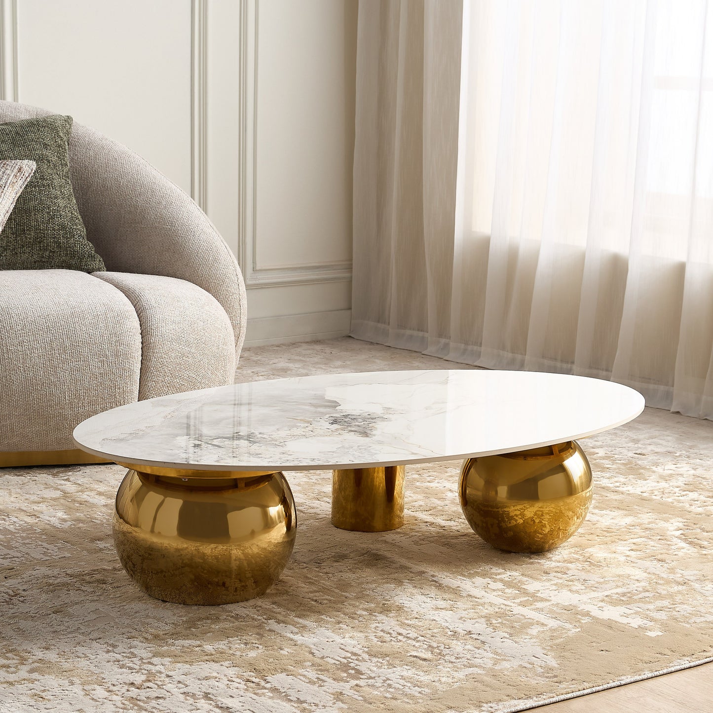 Modern coffee table with gold base and marble top in a living room setting
