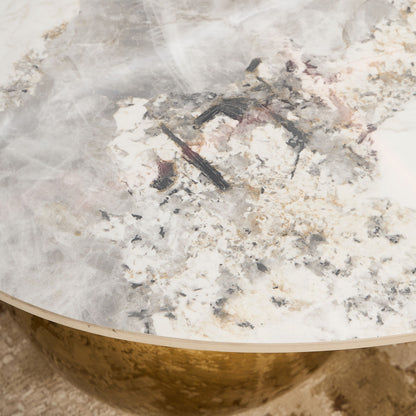 Close-up of a textured stone surface with a bowl partially filled with white powder.