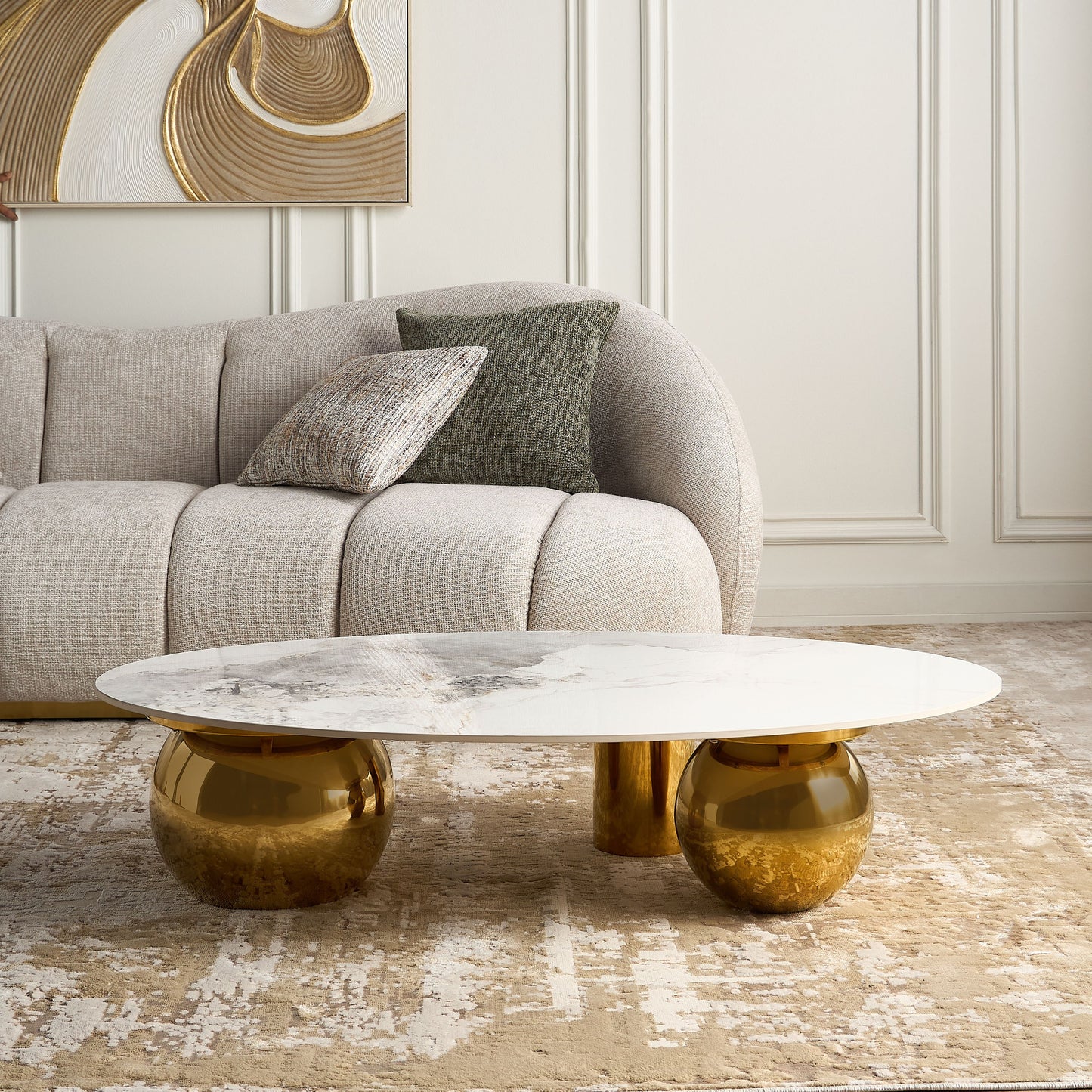Modern coffee table with gold base and marble top in a living room setting.