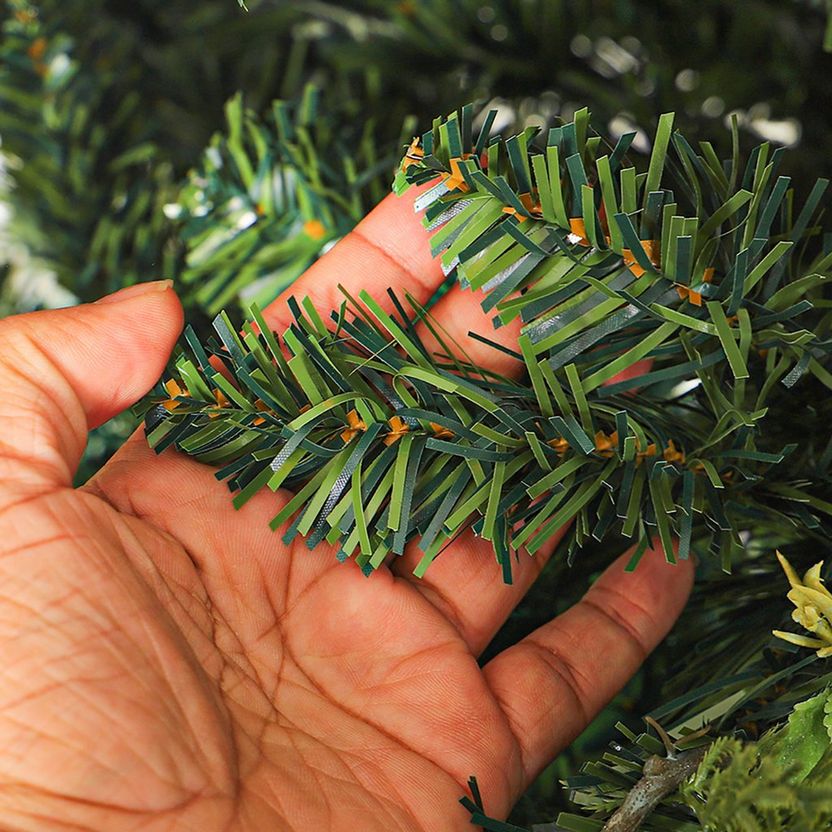 Close-up of a hand holding artificial greenery