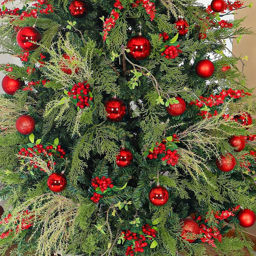 Decorated Christmas tree with red ornaments and berries