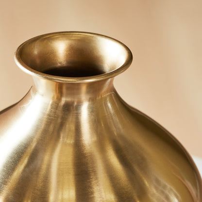 Gold vase on a beige background