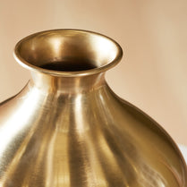 Gold vase on a beige background