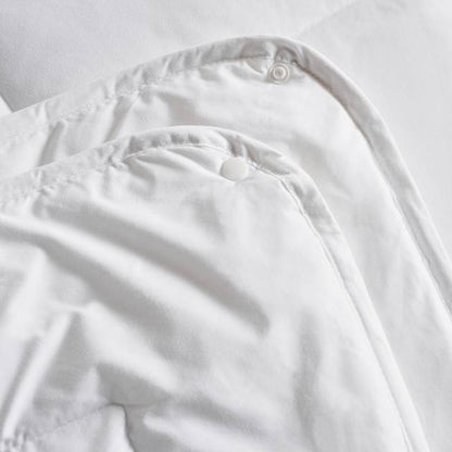 Close-up of a white shirt with buttons on a light gray background