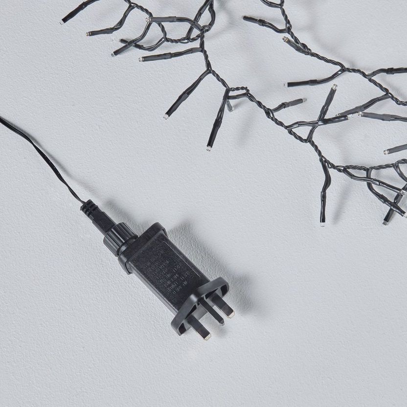 Black electrical plug on a light gray background