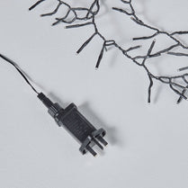 Black electrical plug on a light gray background