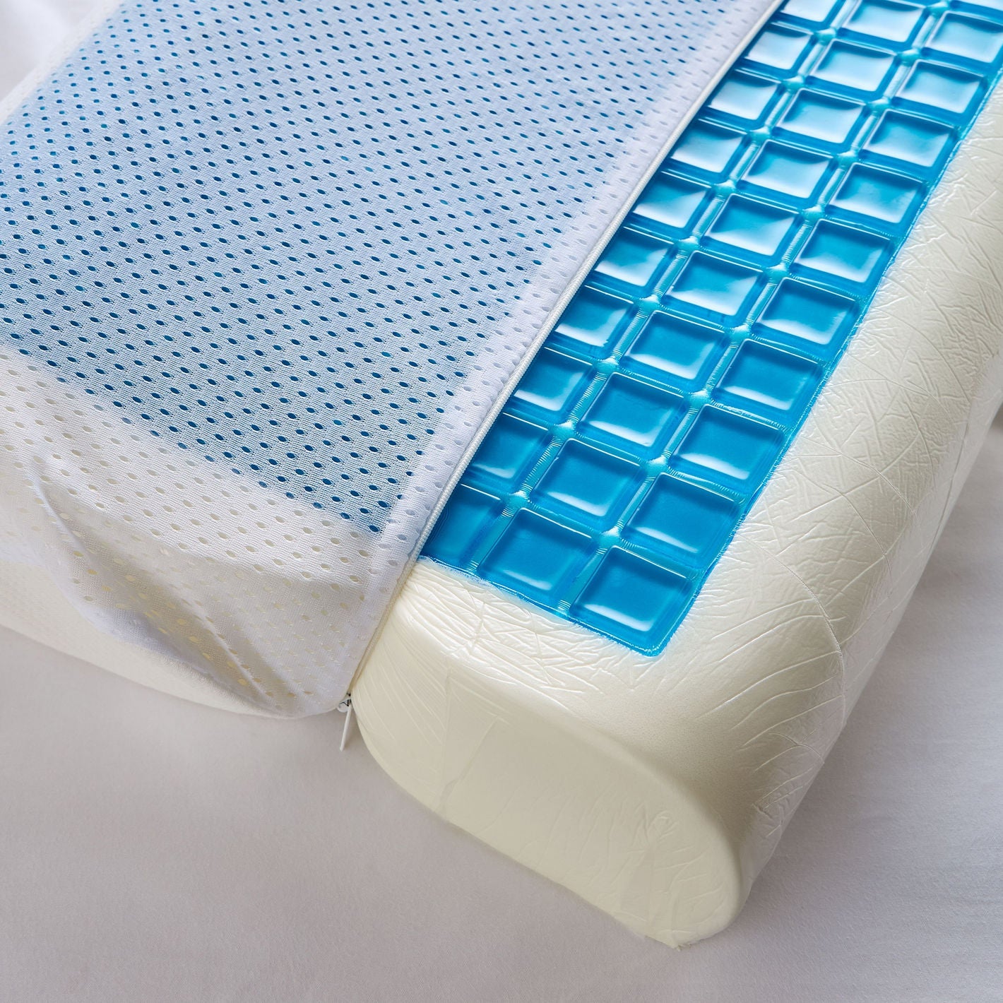 Ergonomic pillow with blue mesh cover and textured blue side on a white background