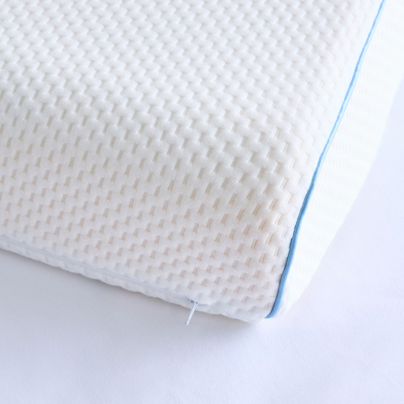 Textured pillow with a blue line on a white background