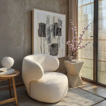 Modern living room with a white armchair, abstract art, and decorative elements.