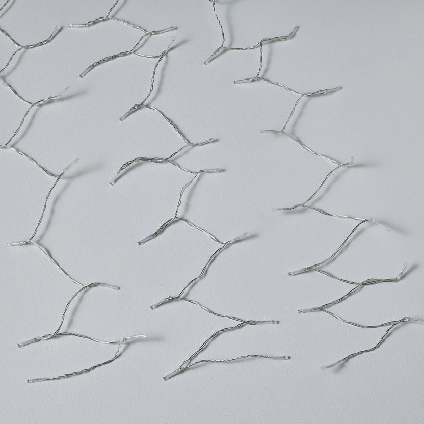 Silver hairpins on a light gray background
