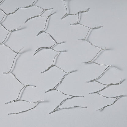 Silver hairpins on a light gray background