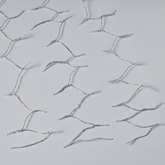 Silver hairpins on a light gray background