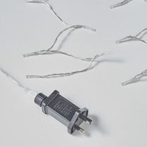 Small electronic device with a plug on a light gray background