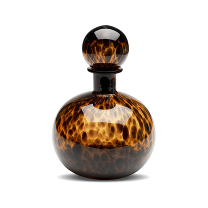 Tortoiseshell-patterned glass decanter on a white background