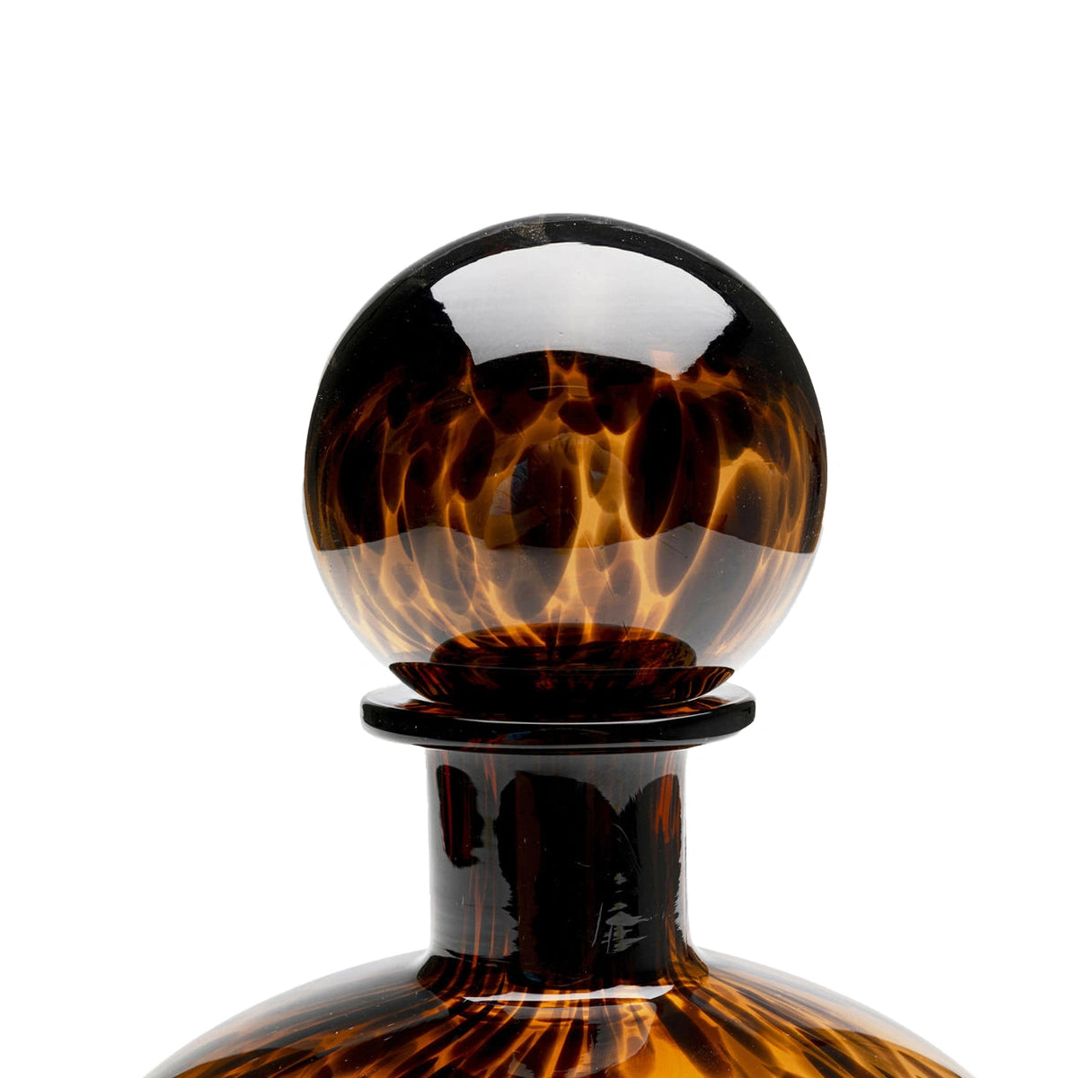 Tortoiseshell glass decanter stopper on a white background