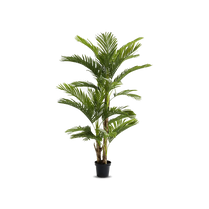 Potted artificial palm tree on a white background