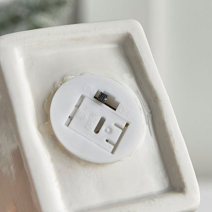 White electronic device with a USB port on a white surface