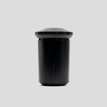 Black container with lid on a light gray background