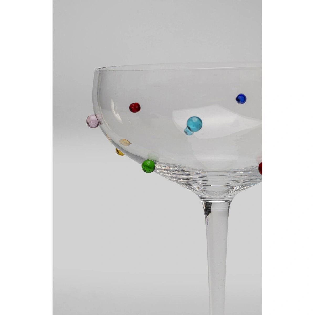Clear glass with colorful beads on a white background