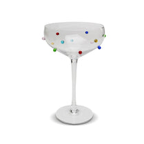 Cocktail glass with colorful dots on a white background