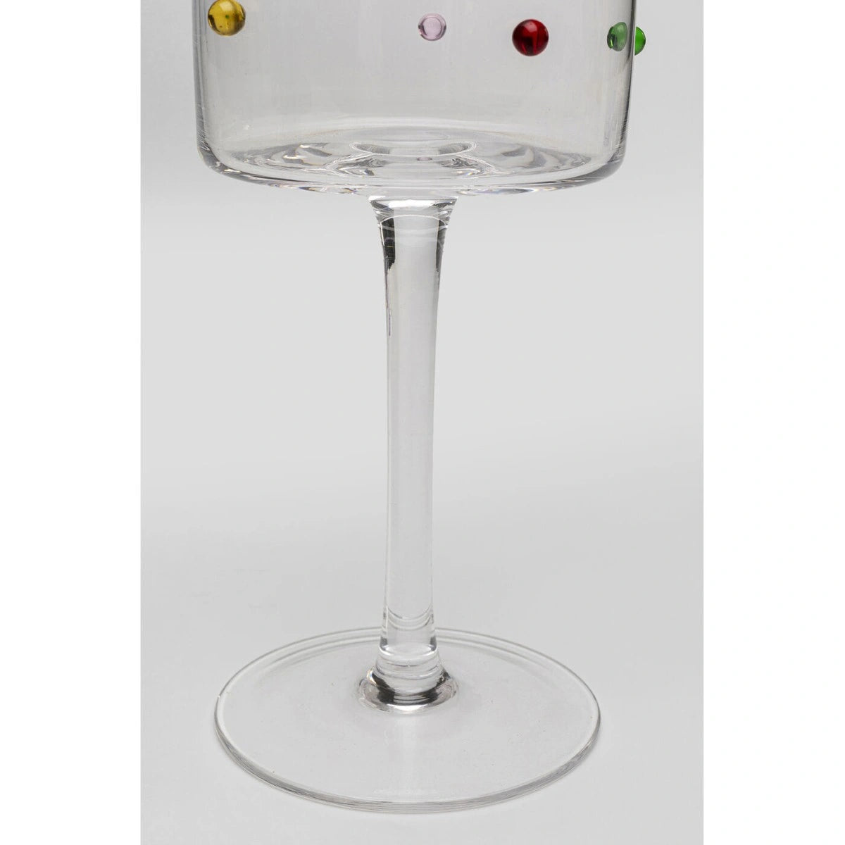 Clear glass with colorful beads on a white background