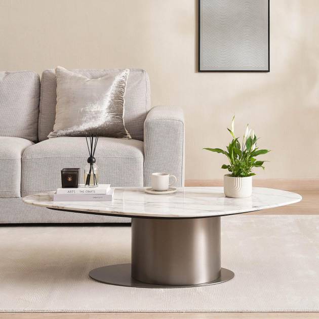 Modern living room with a gray sofa, marble coffee table, and decorative items.
